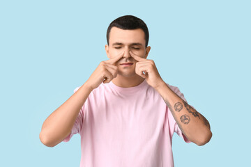 Ill young man on blue background