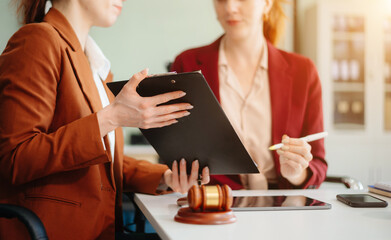  business team and lawyers discussing contract papers sitting at the table. Concepts of law, advice, legal services.