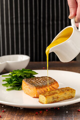 Seared salmon fillet served with wilted spinach and potato croquette