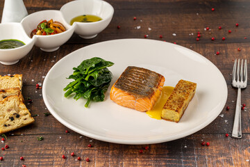 Seared salmon fillet served with wilted spinach and potato croquette