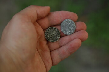 Medieval silver polish coins in hand