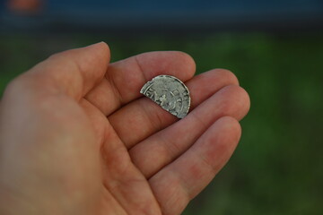 Half of medieval european silver coin in hand
