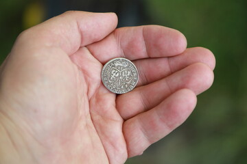 Medieval silver polish coin in hand
