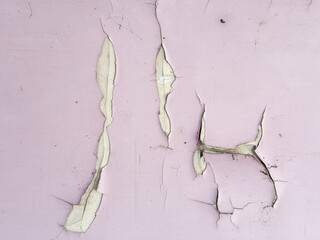 A wall with peeling paint and a crack in the wall