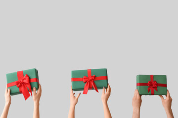 Female hands holding Christmas gift boxes on white background