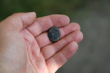 Medieval copper English coin in hand