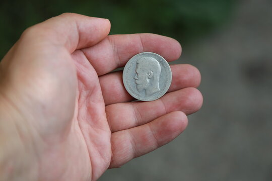 Silver coin one ruble of Russian Empire in hand