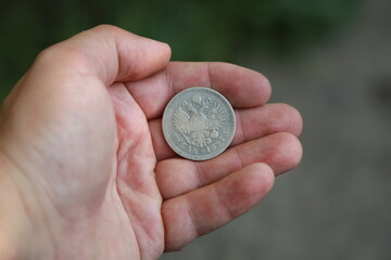 Silver coin one ruble of Russian Empire in hand