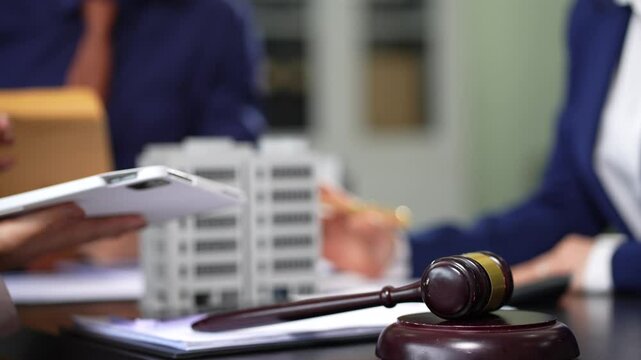 Justice and law concept. Real Estate Law in a courtroom the gavel, working with digital tablet computer.