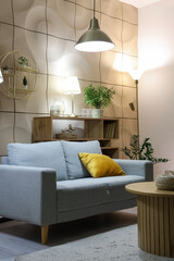 Interior of living room with glowing lamps and sofa at night