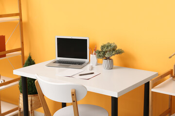 Interior with comfortable workplace near color wall