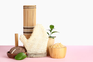 Set of spa supplies on color table against white background