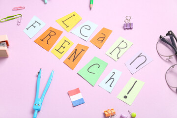 Composition with text LEARN FRENCH and different stationery on pink background