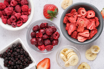 Bowls with freeze-dried fruits on white background © Pixel-Shot