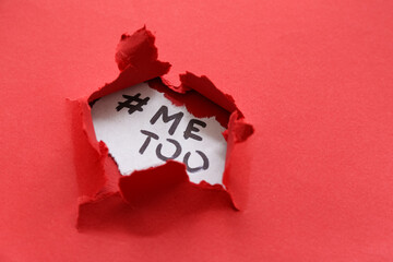 Hashtag METOO visible through torn red paper