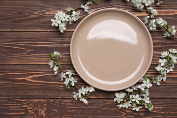 Beautiful table setting with blossoming branches on wooden background