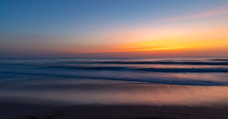 The colors of dawn at the ocean using intentional camera movement
