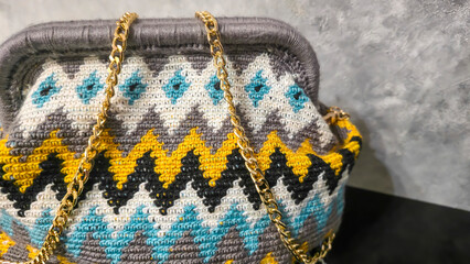 Bag crocheted from multi-colored threads Yellow with gray black and other colors