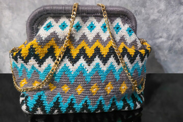 Bag crocheted from multi-colored threads Yellow with gray black and other colors