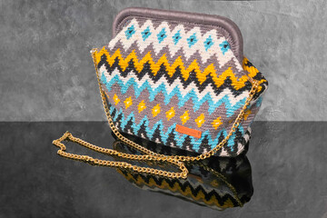 Bag crocheted from multi-colored threads Yellow with gray black and other colors
