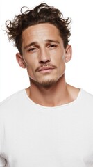 Fototapeta premium Wind-tousled hair catches the light around a contemplative European man, evoking moody autumnal solstice reflections