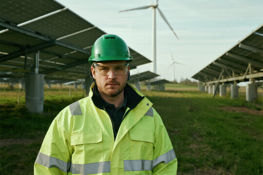 Solar Farm Technician in Green Safety Gear - Powered by Adobe