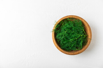 Dill on wooden background. Fresh organic greens. Dill plantation. Cut dill leaves. Bunch of spring young dill. Vitamins. Fiber. Aromatic culinary spice. Place for text. Copy space
