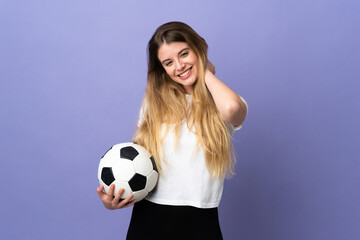 Young blonde football player woman isolated on purple background laughing