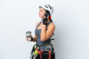 Young Ukrainian rock climber woman isolated on white background holding coffee to take away and a...