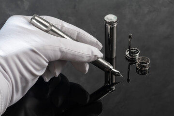 Fountain pen with box on dark gray background. Stationery branded items