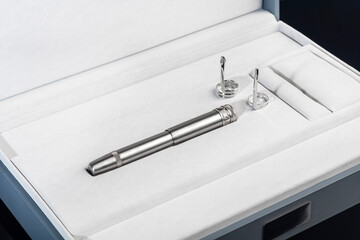 Fountain pen with box on dark gray background. Stationery branded items
