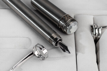 Fountain pen with box on dark gray background. Stationery branded items