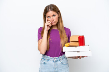 Young pretty blonde woman holding fast food isolated on white background thinking an idea