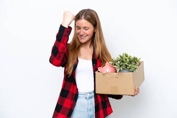 Young caucasian woman making a move while picking up a box full of things isolated on white...