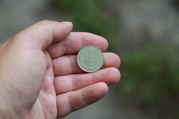 Soviet coin one ruble in hand