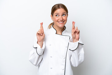 Young chef woman isolated on white background with fingers crossing