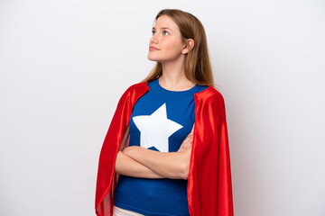 Young caucasian woman isolated on white background in superhero costume with arms crossed © luismolinero
