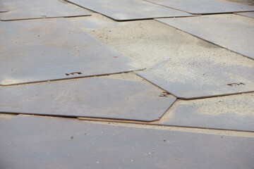 metal plates lie on the ground to protect it from heavy vehicles