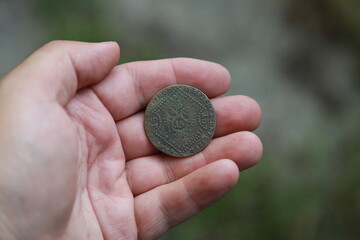 Old Austrian copper coin in hand