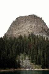  Mirror Lake with Towering Mountain and Evergreen Forest