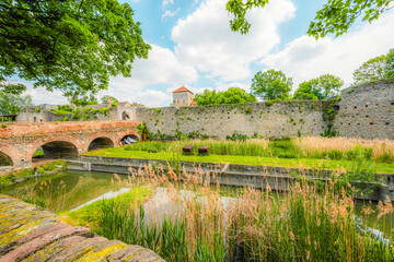 Old stone Tata Castle - 14th-century castle and museum with restored rooms and garden in Tata town,...