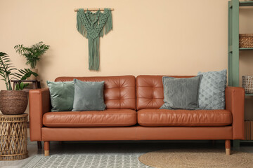 Cozy sofa and houseplants in interior of living room