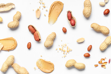 Composition with peanuts and smears of butter on light background