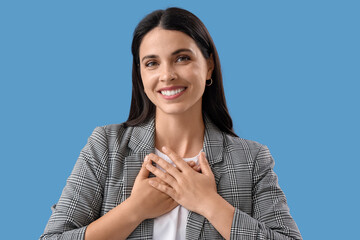Thankful young woman on blue background