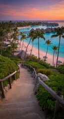 Obraz premium Scenic tropical stairway leading down to a turquoise lagoon with overwater bungalows and palm trees at sunset