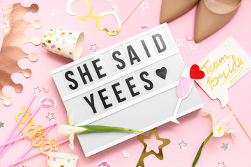 Board with text SHE SAID YES and decor for Hen Party on pink background