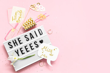 Board with text SHE SAID YES and decor for Hen Party on pink background