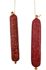 Two hanging raw smoked sausage isolated on white background