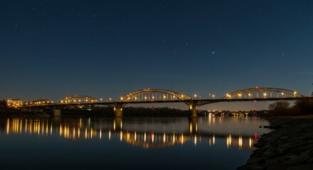 Obraz premium Illuminated bridge at night over river