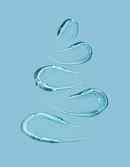 Christmas tree concept in the form of cosmetic strokes on a blue background. Gel smear. Winter concept.
